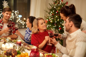 friends celebrating christmas and drinking wine